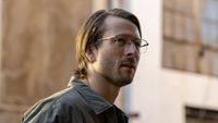 Glen Powell wearing glasses and collared shirt with long-ish hair in Netflix's Hit Man