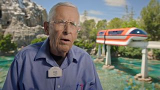 Bob Gurr talking in front of Matterhorn and Monorail in The Imagineering Story